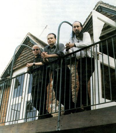 Picture of Ian Lovett, Simon Carter and Dene Carter staring moodily from a balcony